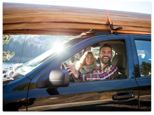 couple in SUV smiling outdoors