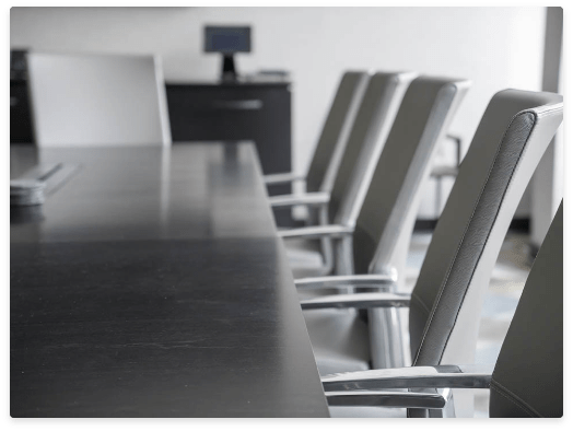 chairs and long table in a meeting room