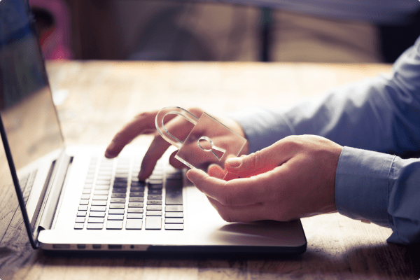 person using laptop with lock in hand