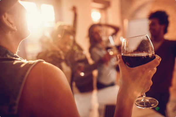 lady at an event drinking wine